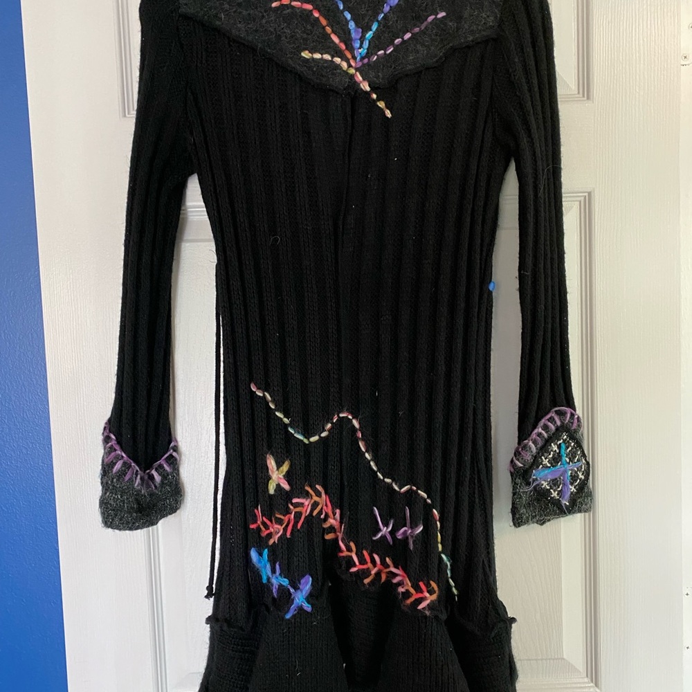 Black sweater with multi colored stitching. Front tie.